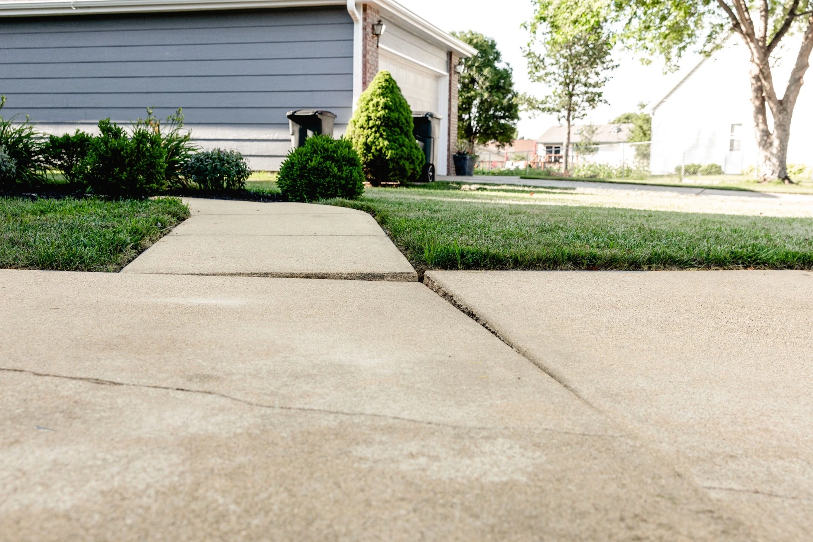 Cracked and settled sidewalk needing concrete repair in Portland Oregon