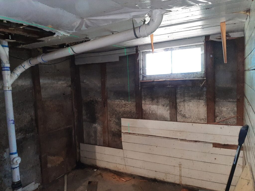 Empty basement with exposed pipes