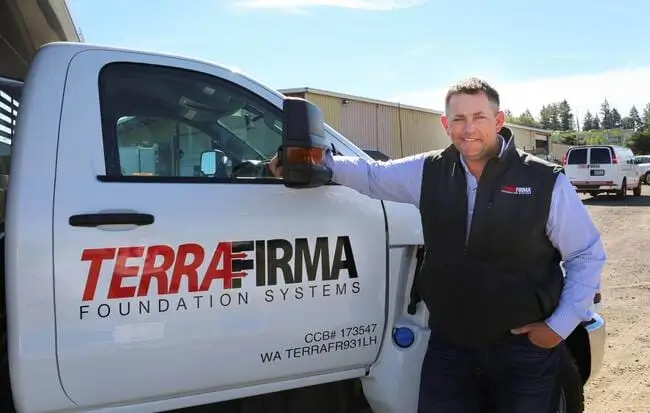 Homepage Ryan Beckley, president of Terrafirma, stands next to a truck with the company logo