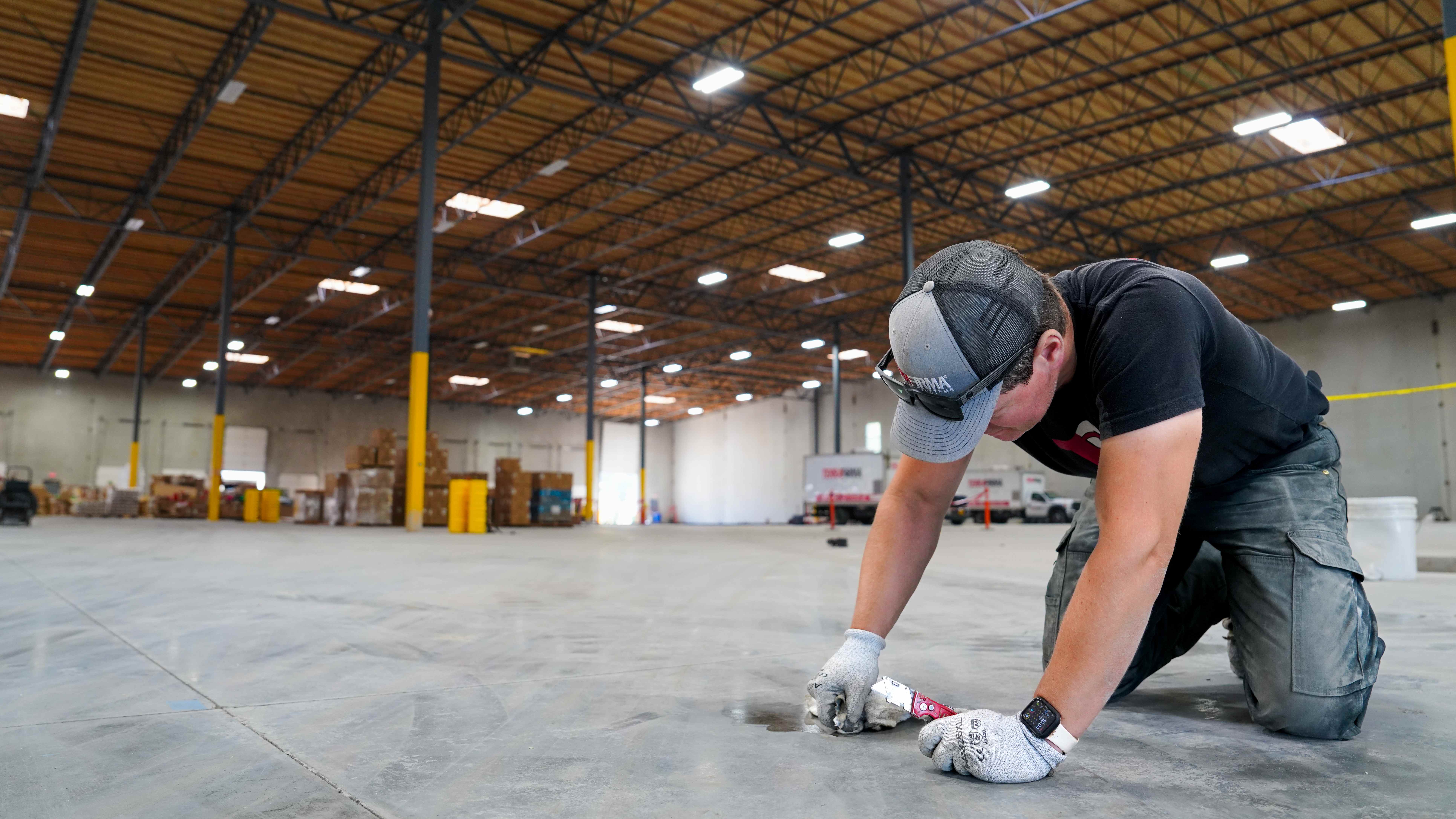 TerraFirma specialist inspecting a concrete surface for concrete repair in Portland OR