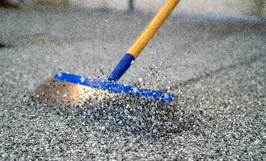 Scraping excess flakes from epoxy floor in Olympia