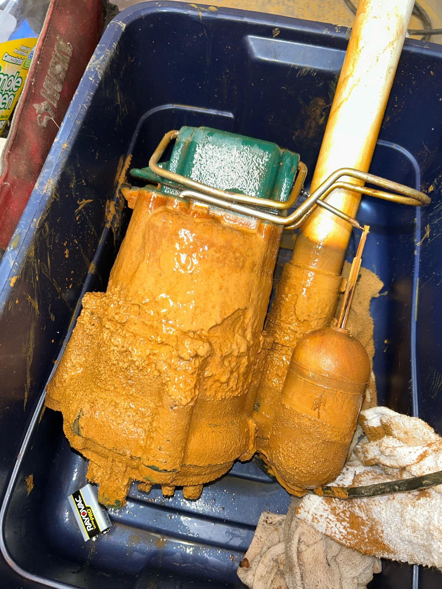 Heavy iron ochre buildup covering sump pump equipment